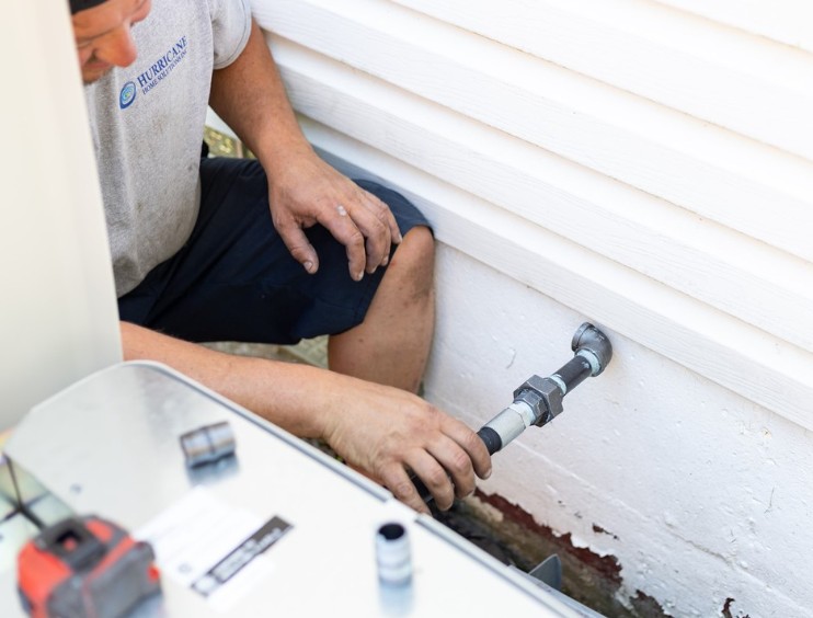 Hurricane Generators technician connecting gas line for a standby generator